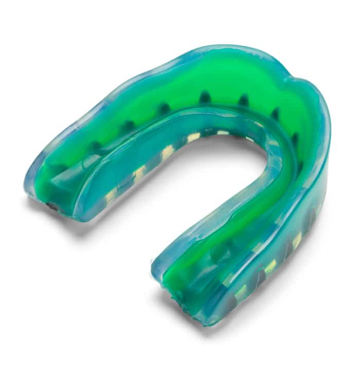 A green and blue plastic mouthguard with multiple layers designed for dental protection, often used in sports. No landmarks or historical buildings are visible.